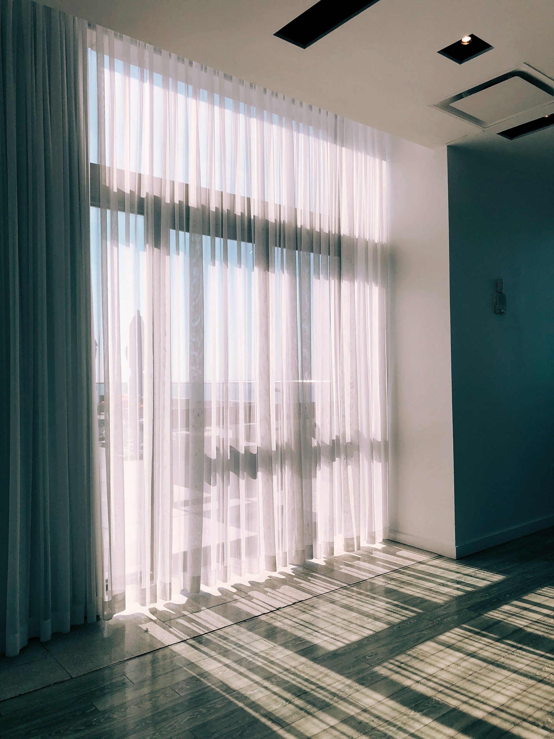 Curtains with sun shing through